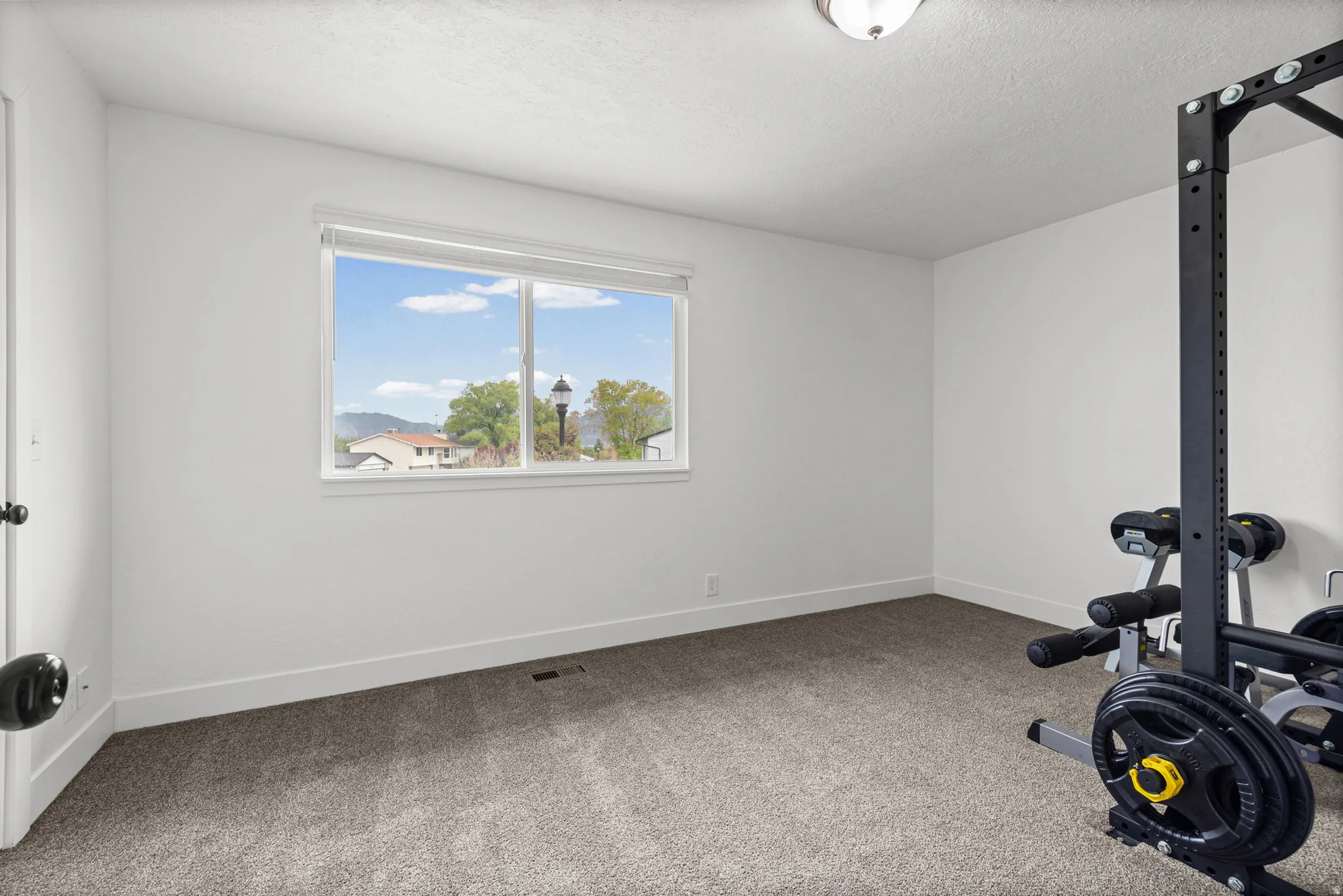 Workout room featuring carpet floors and a textured ceiling
