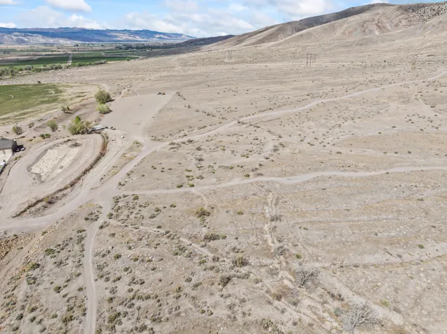Aerial view of sparsely populated area with a mountain backdrop and a desert landscape