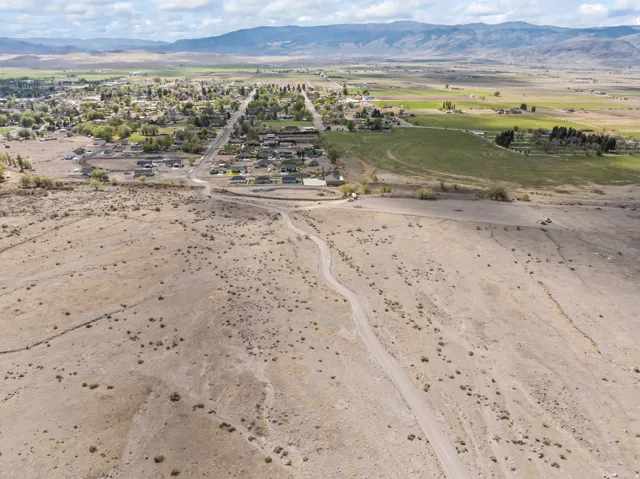 Aerial view of property's location with a mountainous background