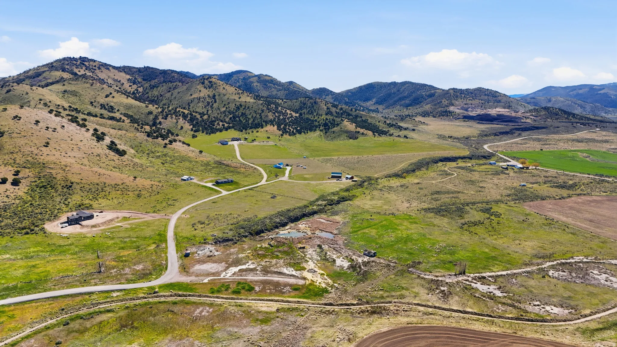 Aerial view of property and surrounding area with mountains and rural landscape