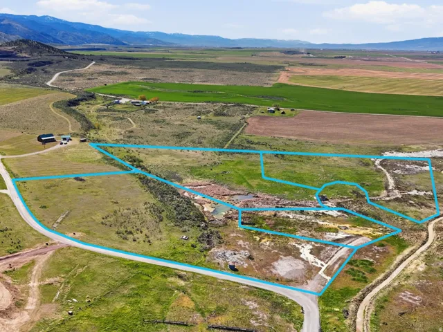 Overview of rural landscape featuring property parcel outlined and a mountain backdrop