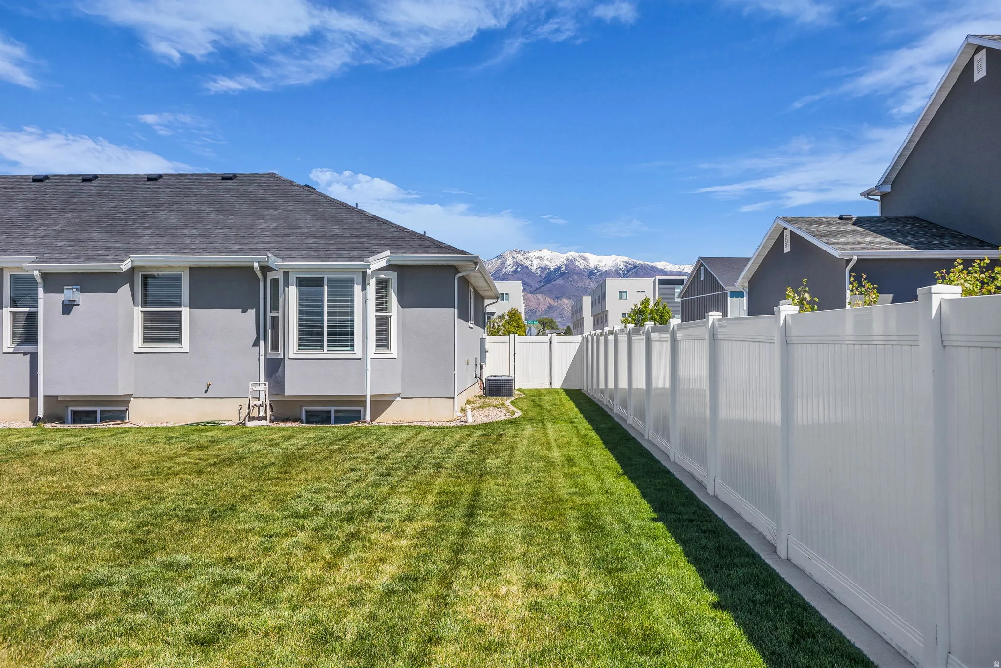 Fenced backyard featuring a mountain view
