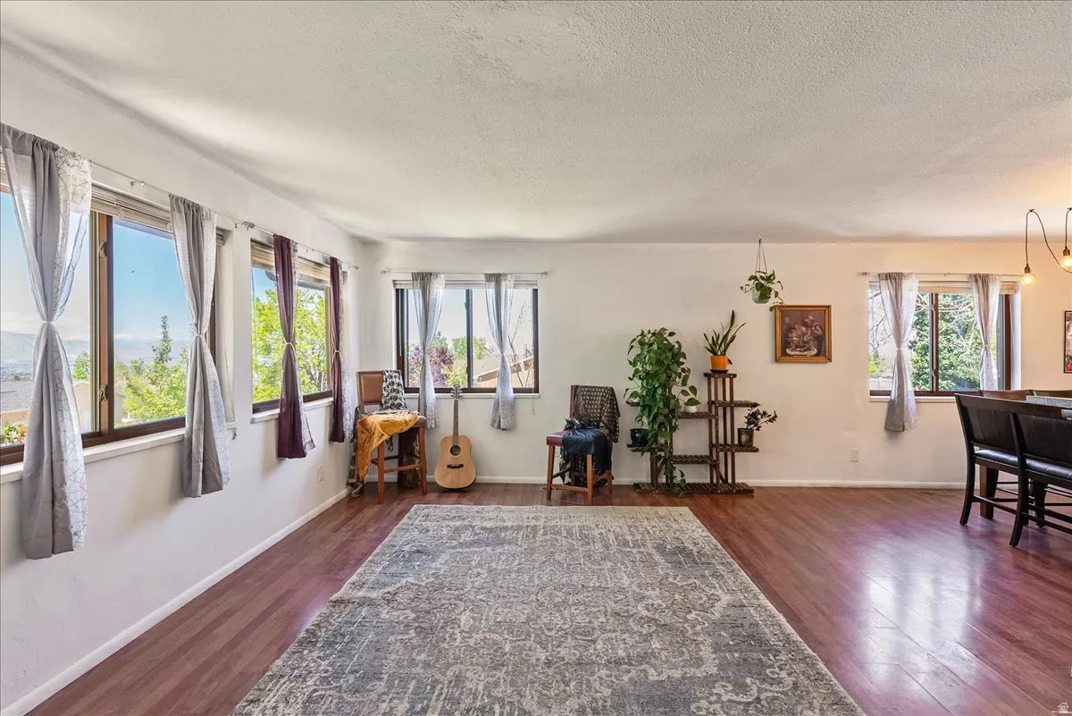 Sitting room featuring a textured ceiling and dark wood-style floors