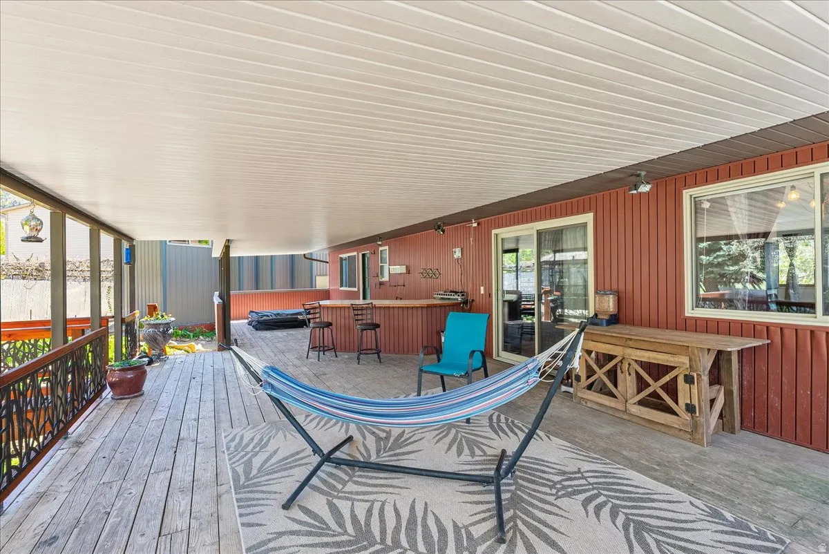 Deck with a hot tub and a patio