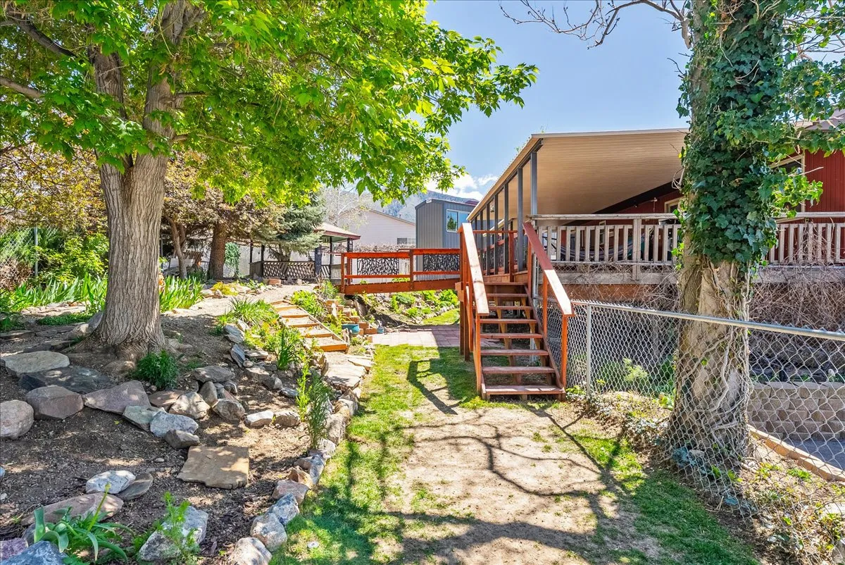View of yard featuring a deck and stairs
