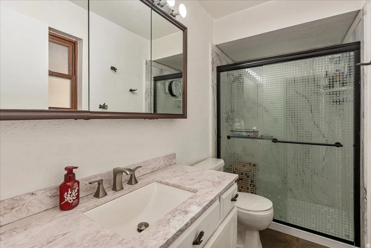 Bathroom featuring vanity and a stall shower