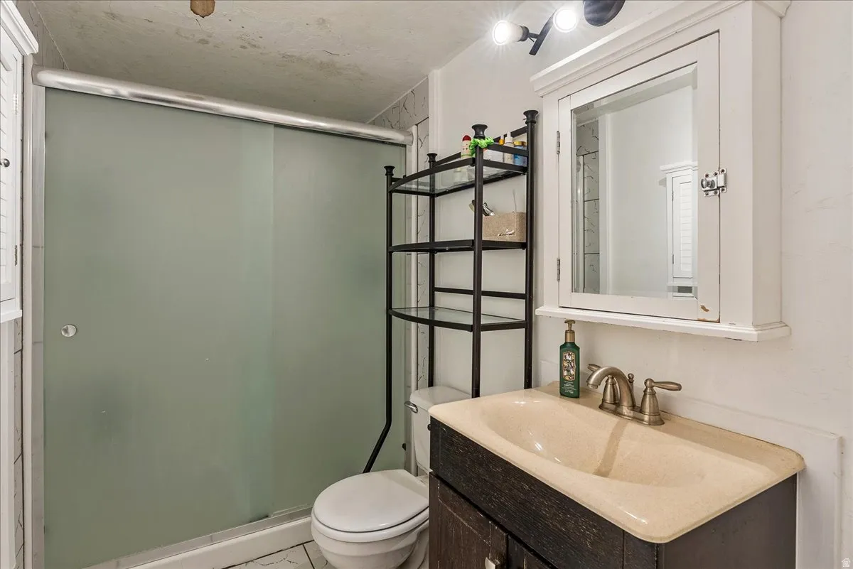 Full bath featuring vanity and a stall shower