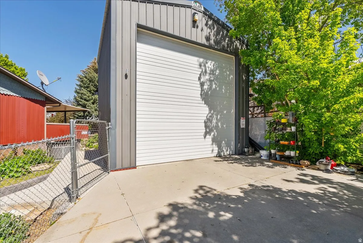 Detached garage with a gate and concrete driveway