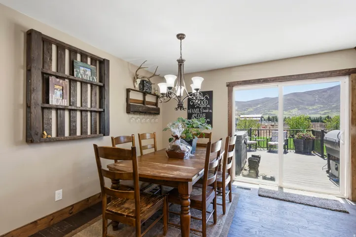Dining area featuring hardwood / wood-style flooring, a chandelier, and a mountain view