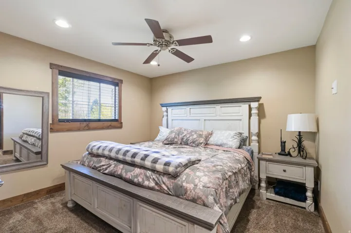 Bedroom featuring ceiling fan, dark colored carpet, and recessed lighting