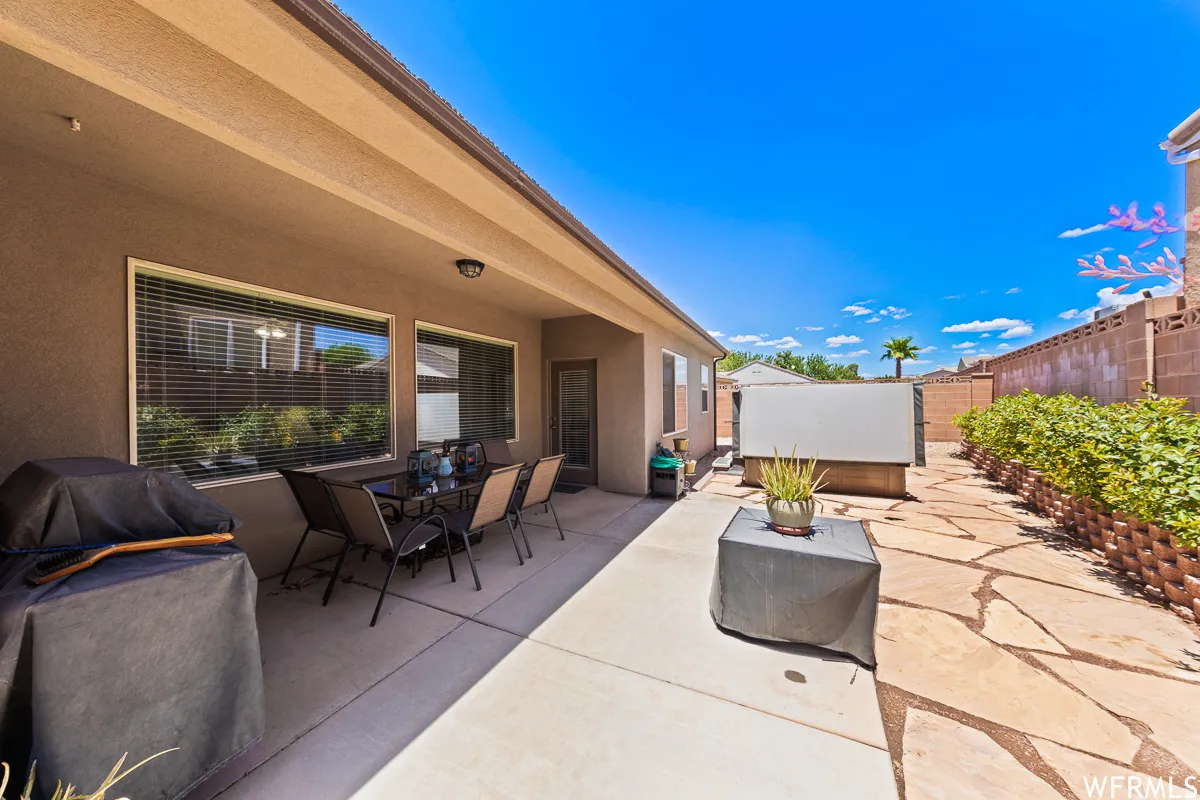 Fenced backyard with outdoor dining area, a patio, and area for grilling