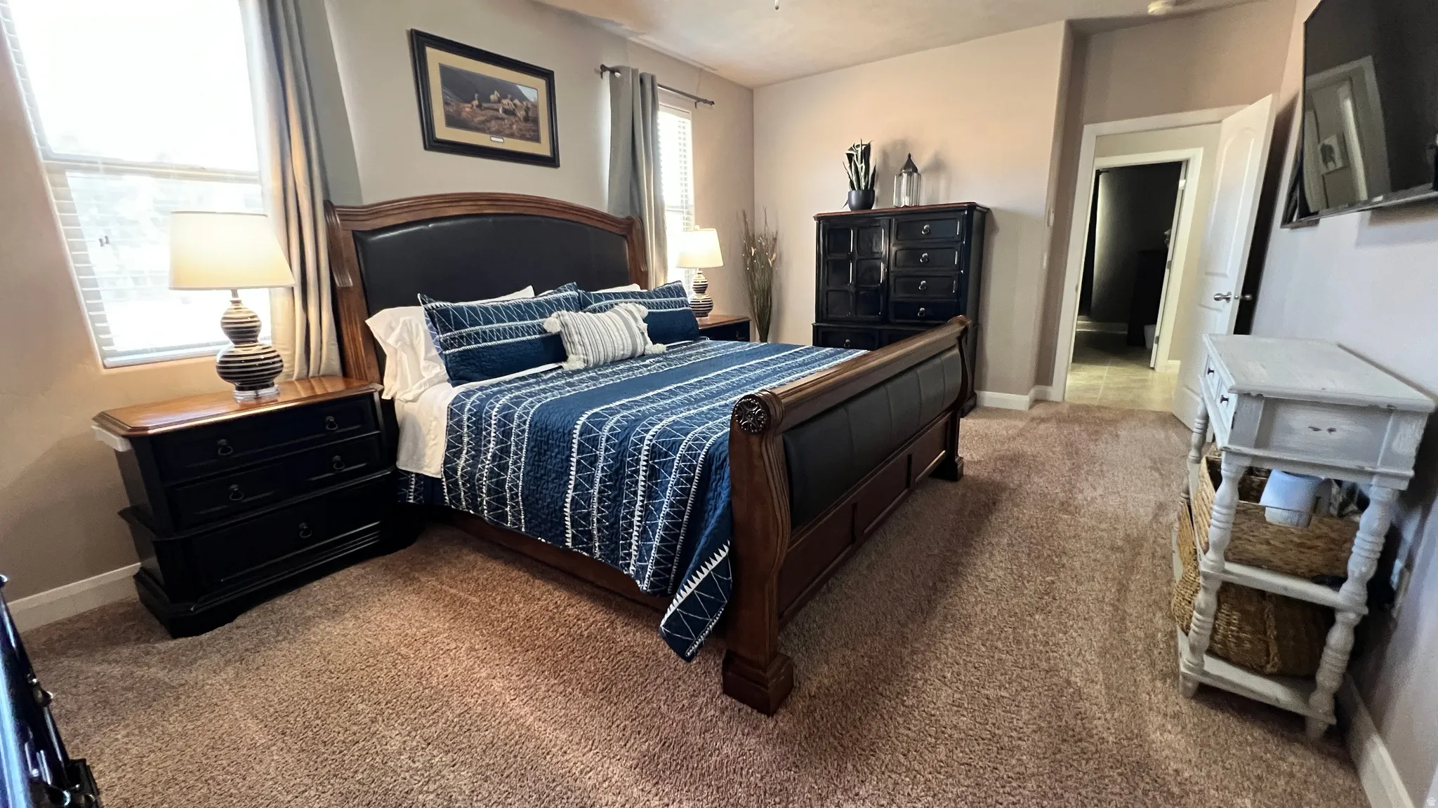 Bedroom with baseboards and dark carpet