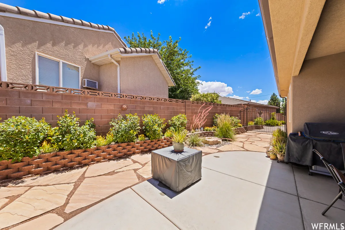 Fenced backyard with a patio area and grilling area