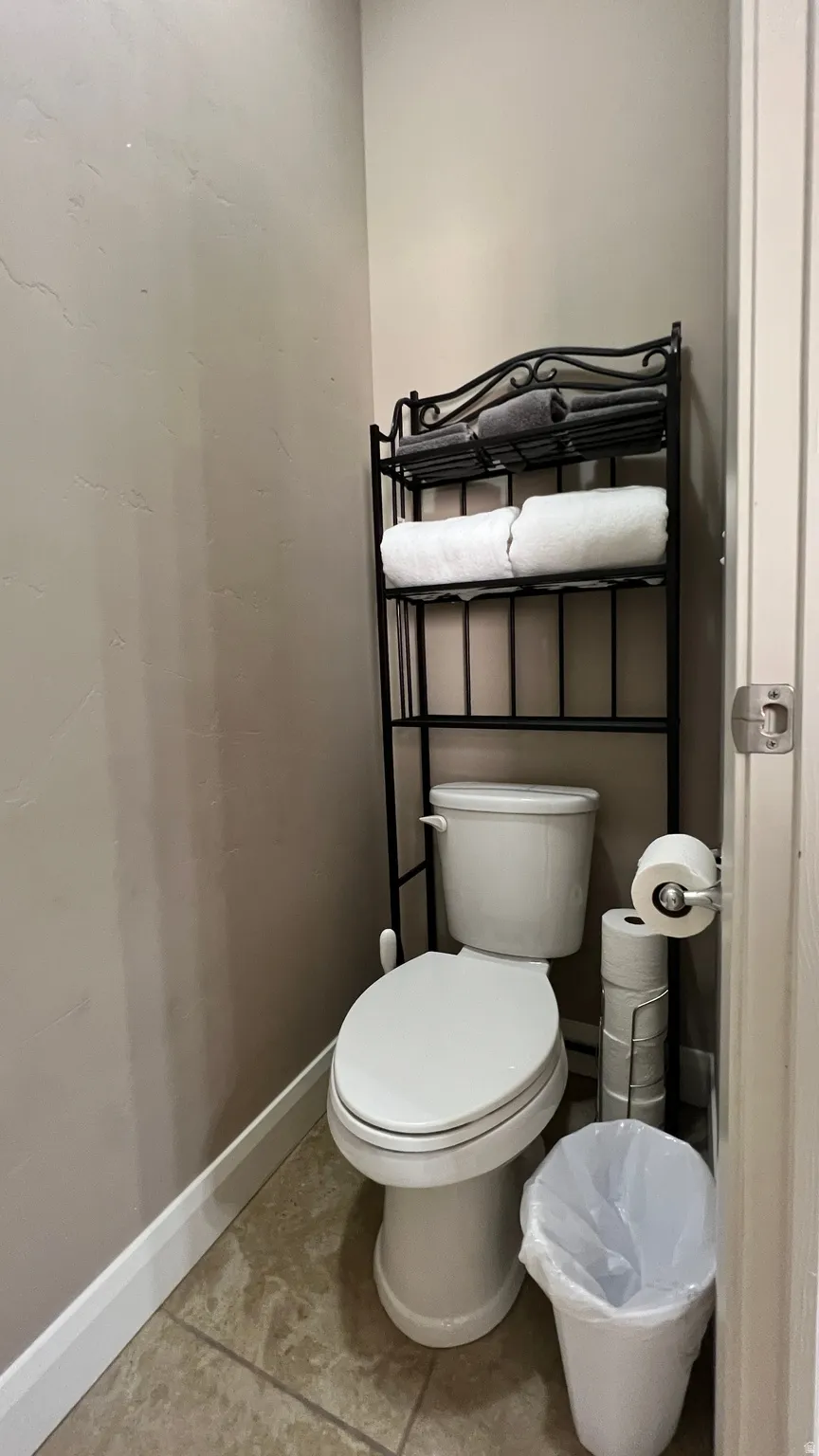 Bathroom with baseboards and light tile patterned floors