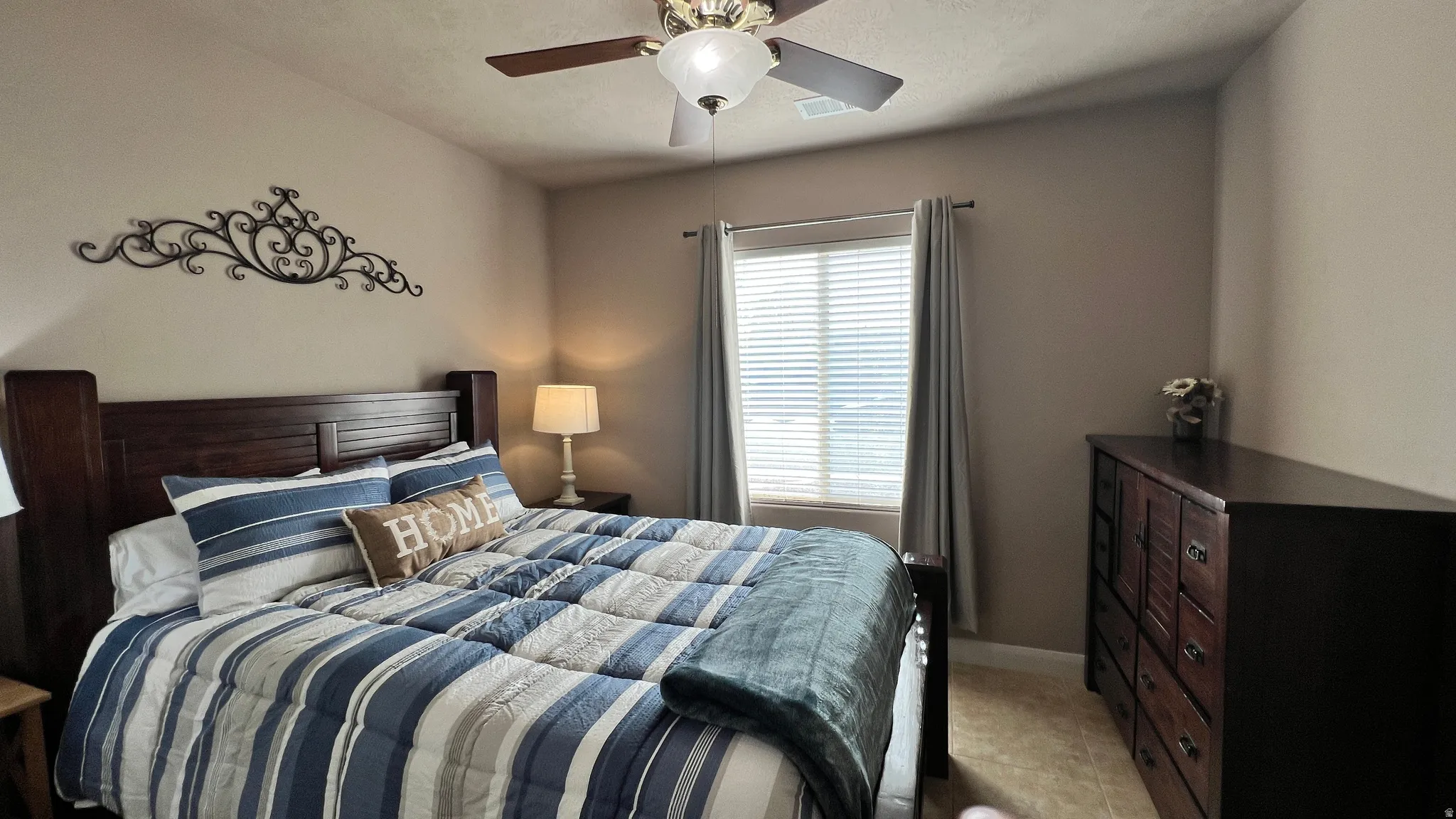 Bedroom with a ceiling fan and baseboards
