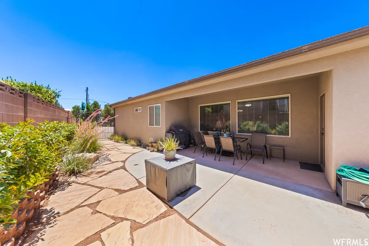 View of patio with outdoor dining space and a grill