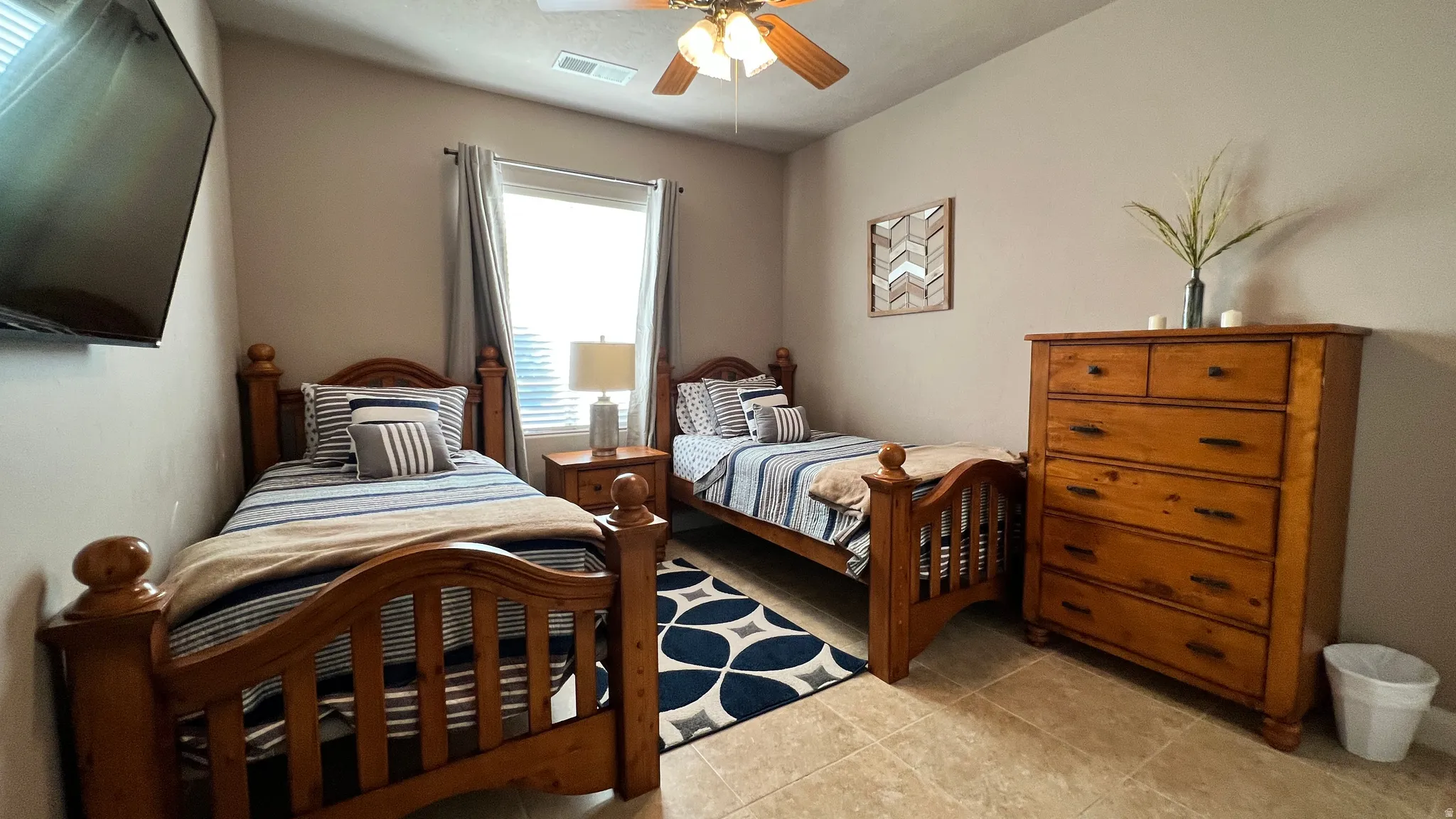 Bedroom featuring a ceiling fan and light tile patterned floors