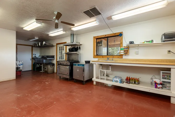 Garage with a ceiling fan and a sink