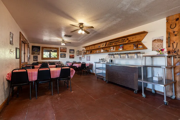 Dining space with a textured ceiling, a textured wall, and ceiling fan
