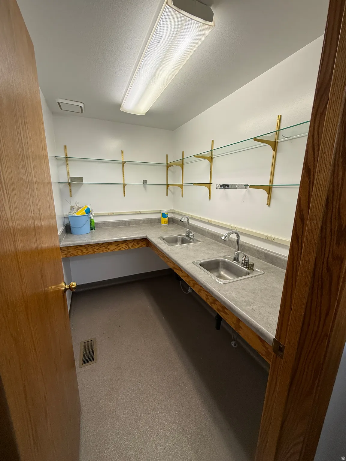 Kitchen featuring a sink and a textured ceiling