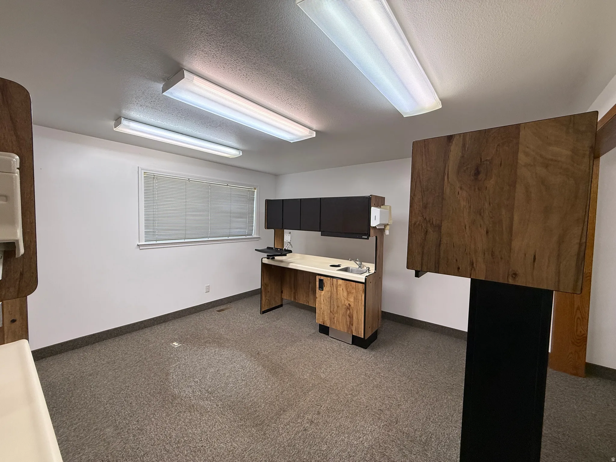Unfurnished office featuring a textured ceiling