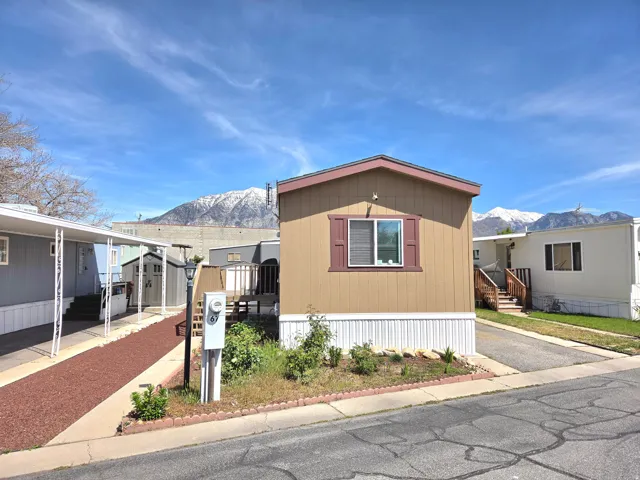 Manufactured / mobile home featuring a mountain view and a storage unit