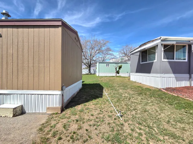 View of grassy yard featuring an outdoor structure