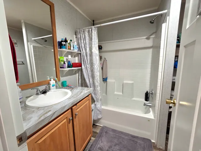 Bathroom featuring vanity and shower / tub combo