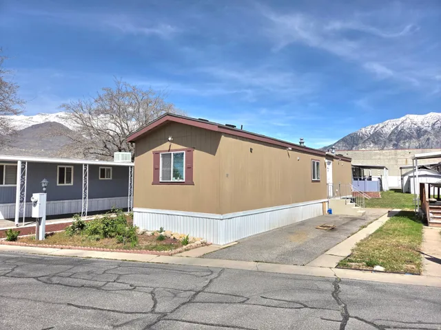 View of home's exterior with a mountain view and a porch