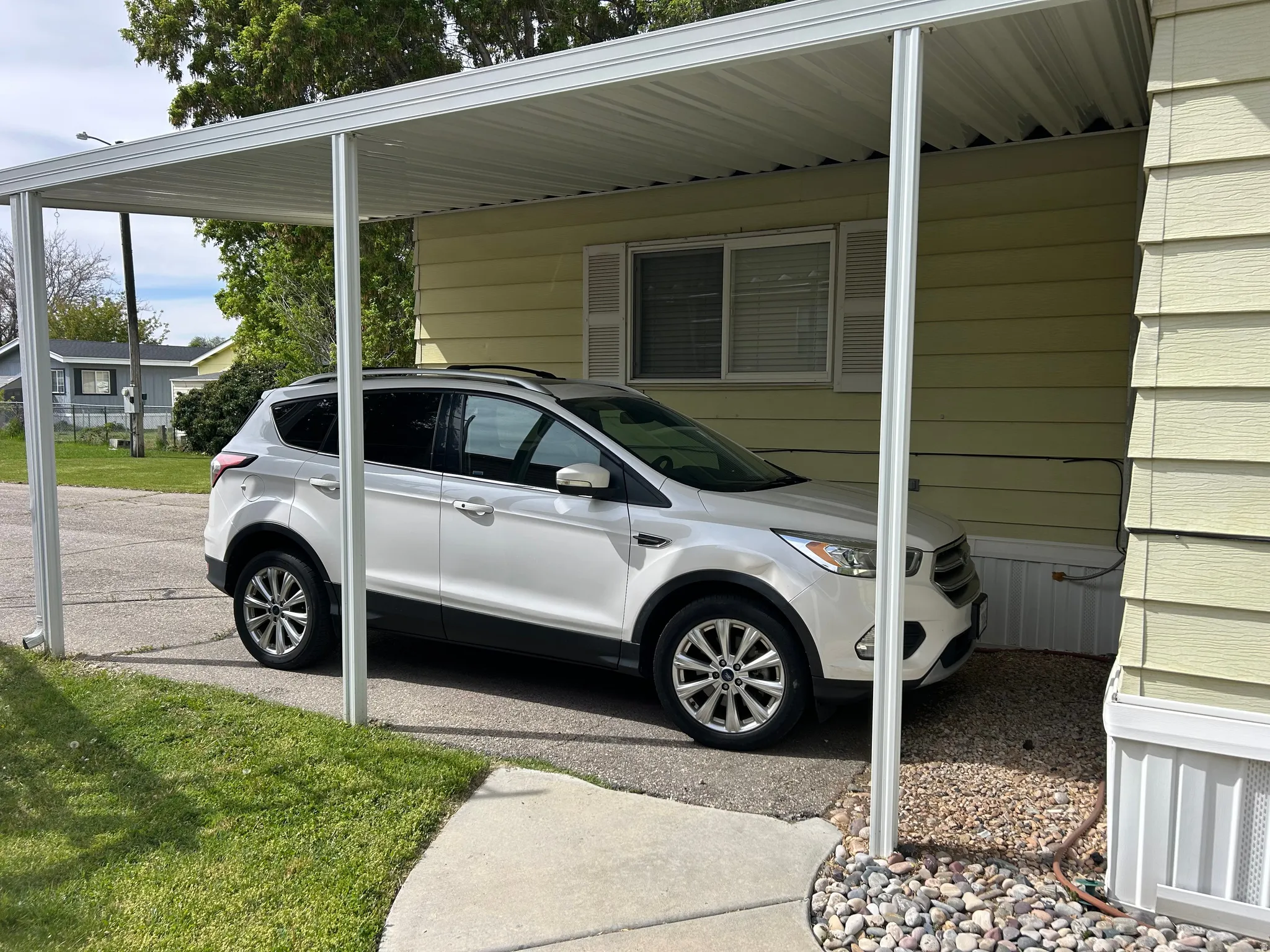 View of parking with an attached carport