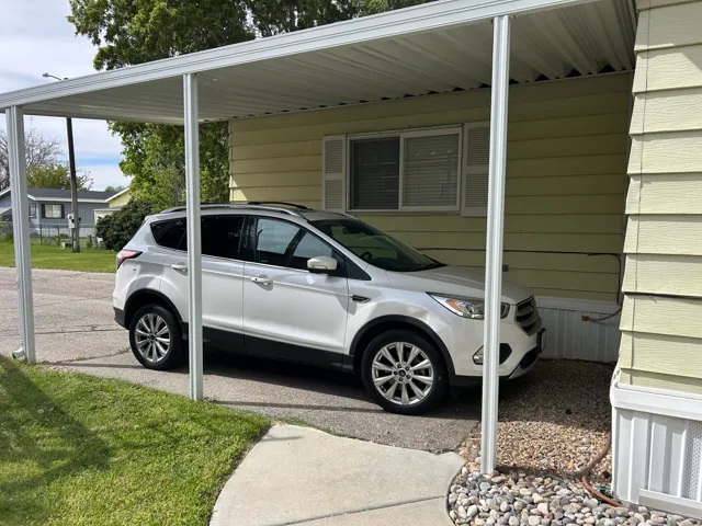 View of parking with an attached carport