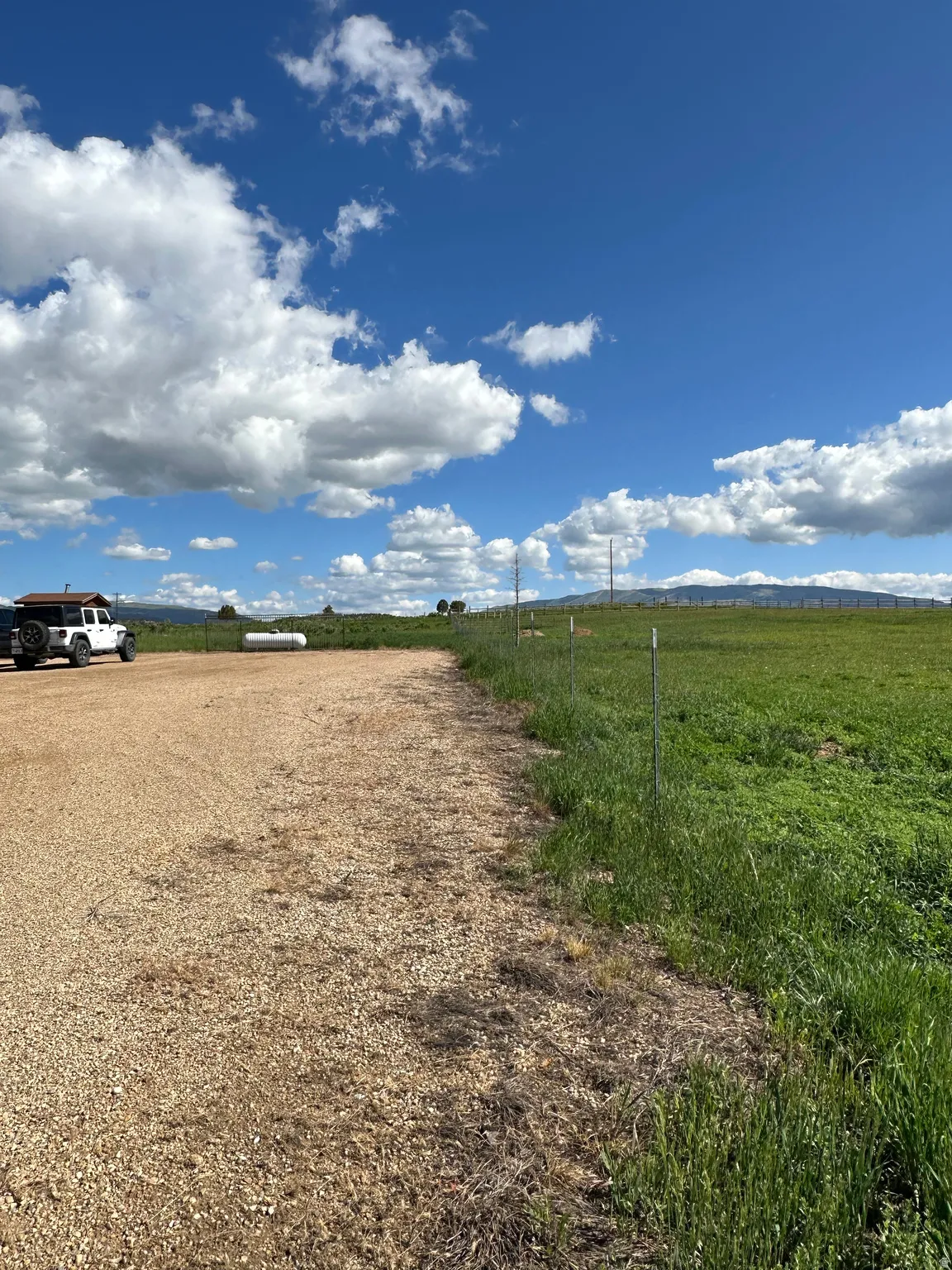 View of dirt / gravel road with a view of countryside