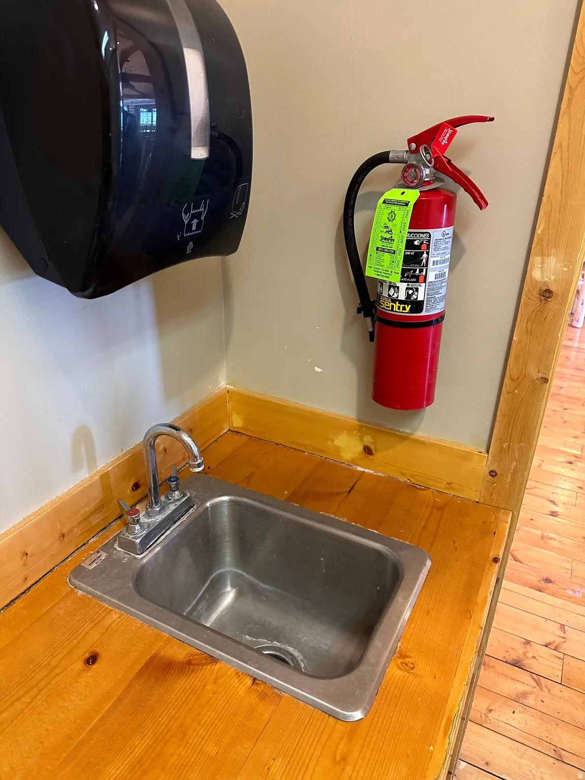 Detailed view of a sink and a fire extinguisher