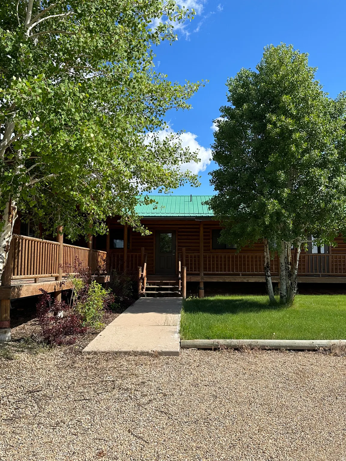 Log cabin featuring a metal roof and a porch