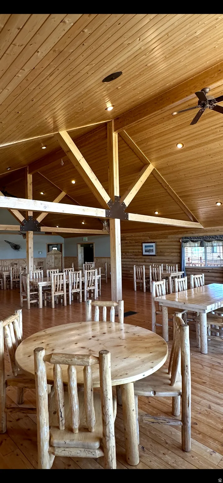 Dining space featuring hardwood / wood-style flooring, a ceiling fan, a vaulted wooden ceiling, and recessed lighting