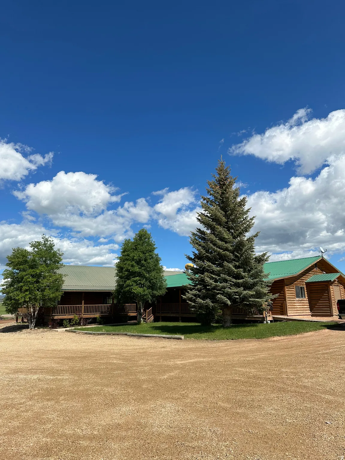 View of green lawn featuring a porch