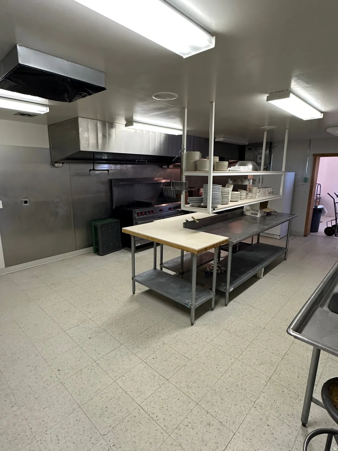 Kitchen featuring wall chimney range hood