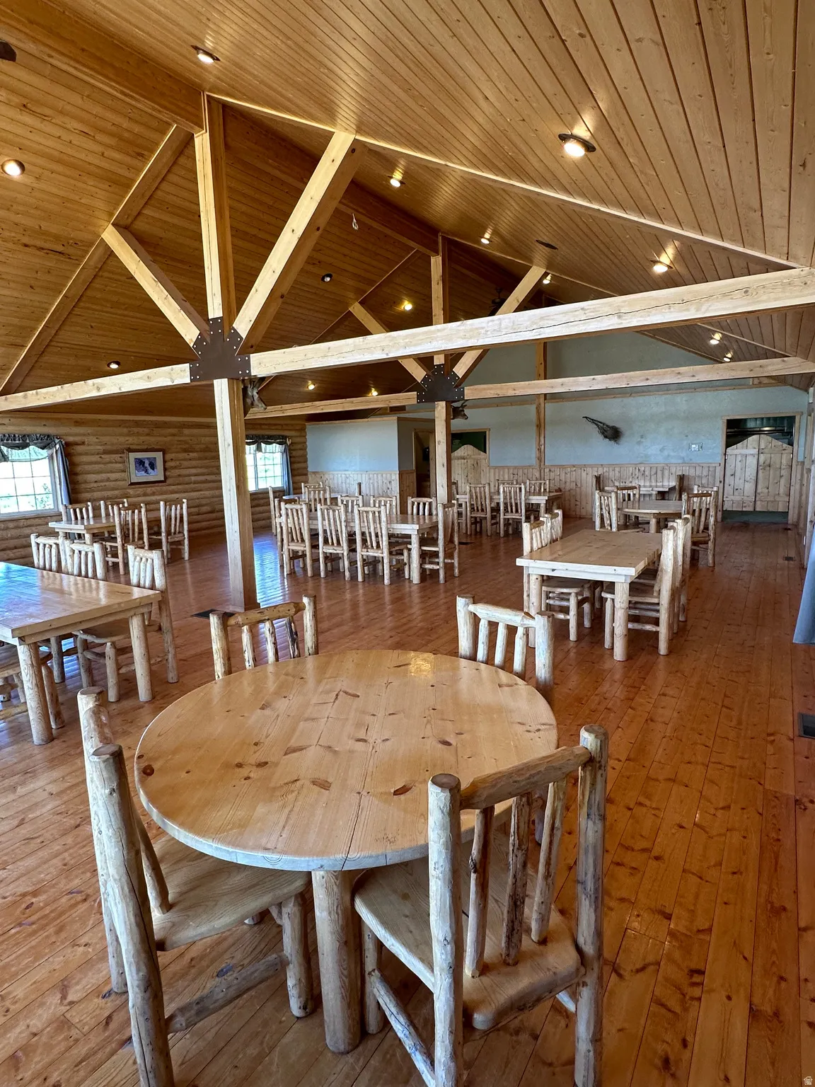 Dining space with a high wooden ceiling, hardwood / wood-style flooring, and plenty of natural light