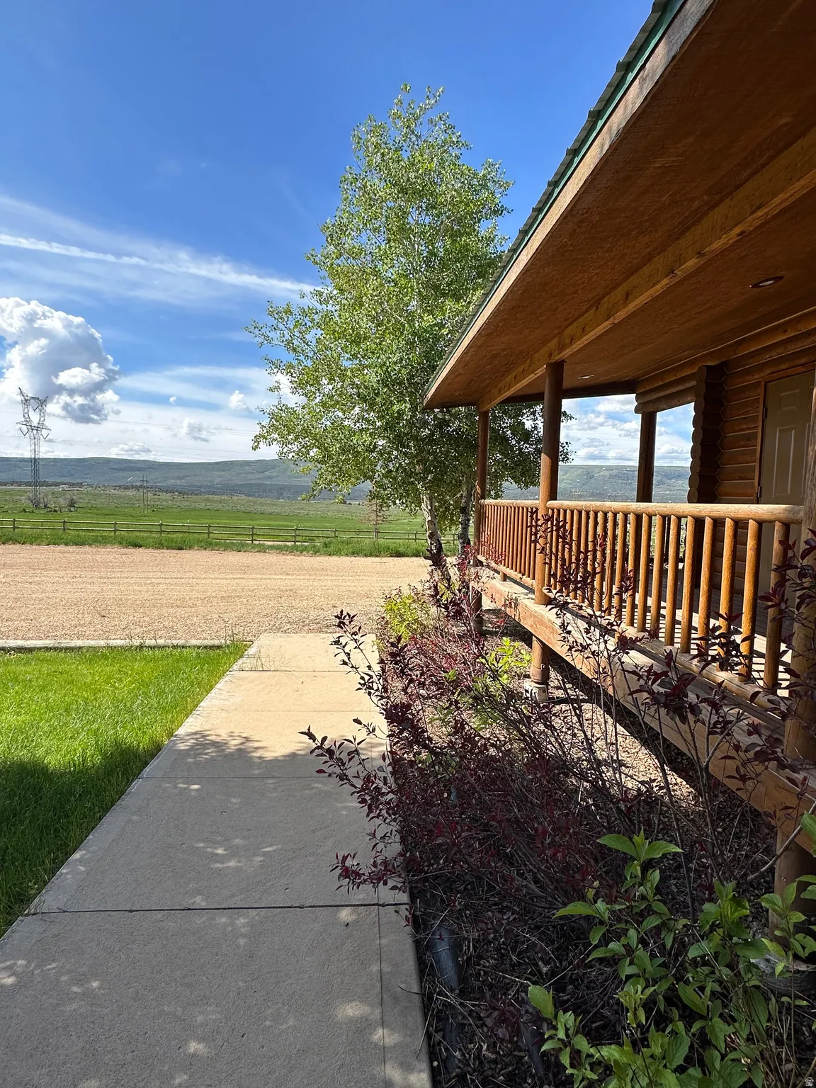 View of yard featuring a rural view and covered porch