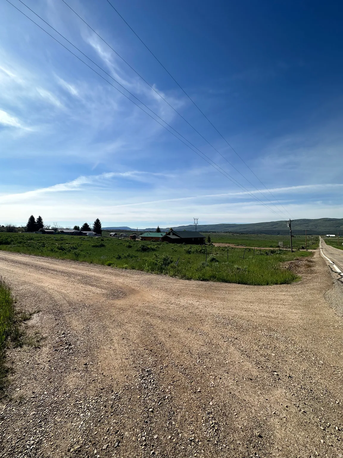 View of dirt / gravel road with a view of rural / pastoral area
