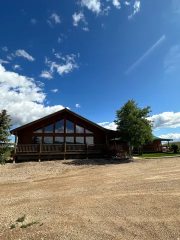 Rear view of property with a large porch