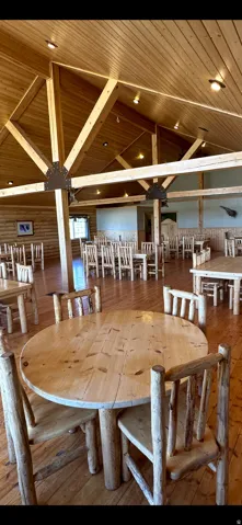 Dining room with a vaulted wood ceiling and hardwood / wood-style flooring