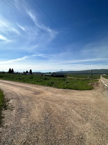 View of dirt / gravel road with a view of rural / pastoral area