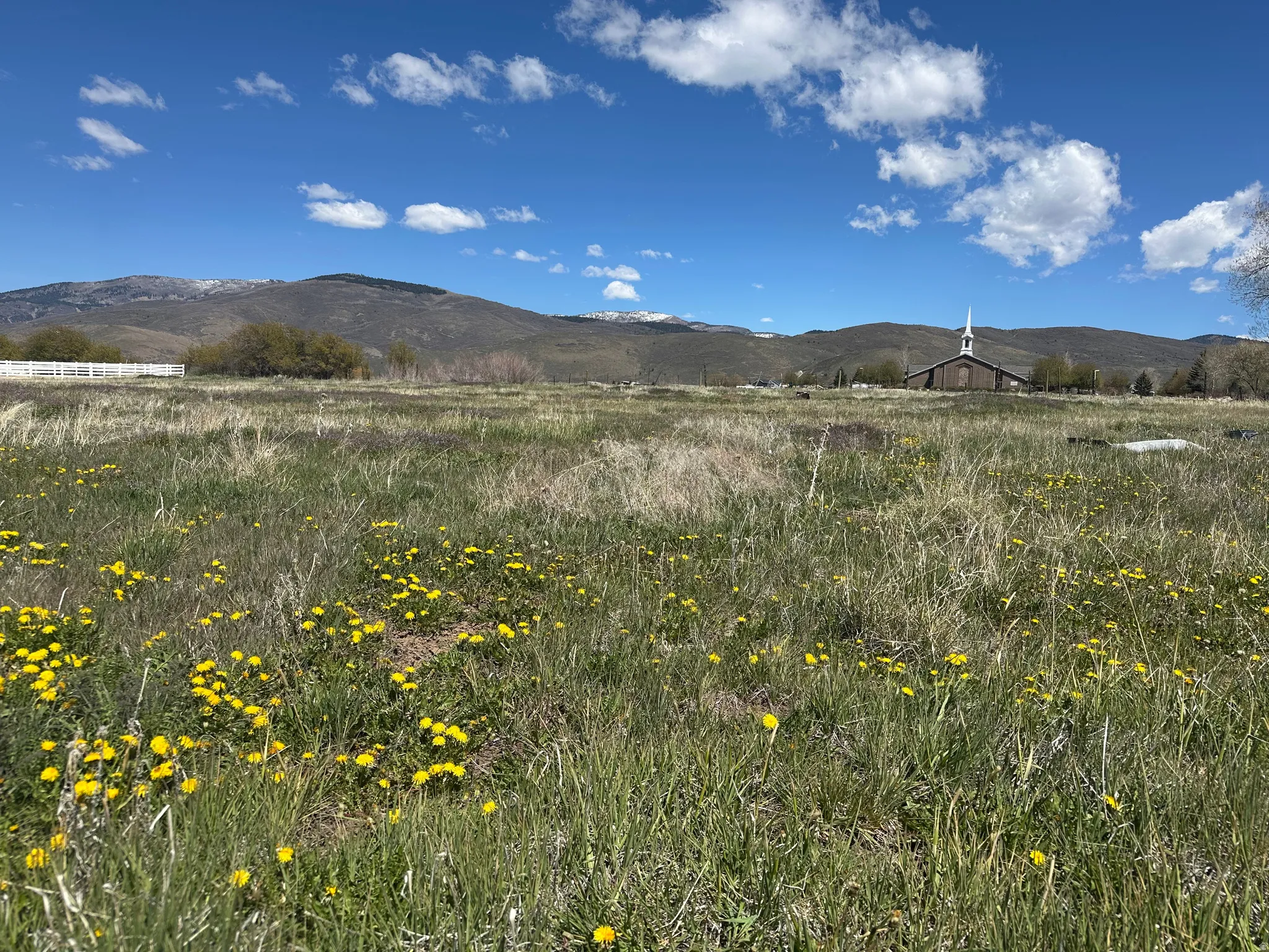 View of mountain backdrop with rural landscape