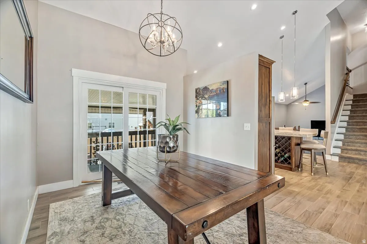 Dining space with light wood-type flooring and suspended lighting