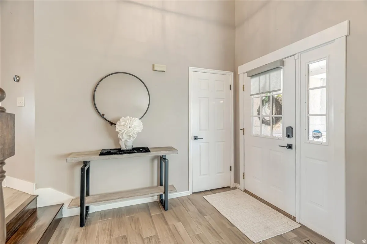 Entrance foyer featuring light wood finished floors and baseboards