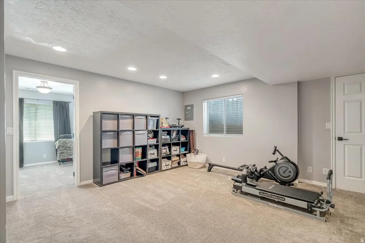 Workout area with a textured ceiling, carpet floors, plenty of natural light, and recessed lighting