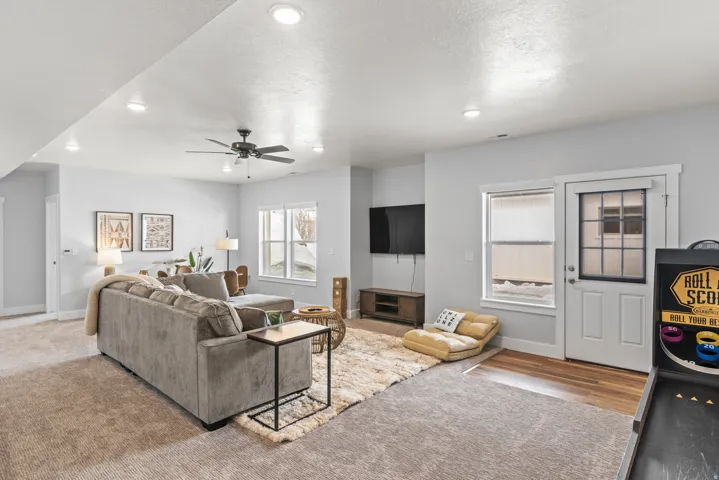 Living room with recessed lighting, a ceiling fan, carpet floors, and a textured ceiling