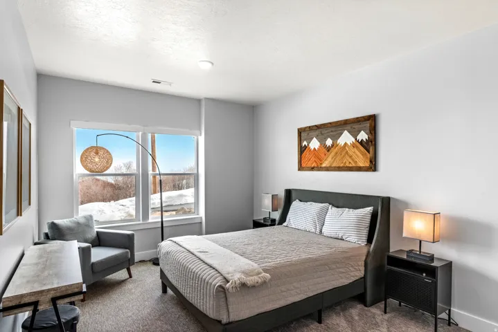 Bedroom featuring carpet floors and baseboards