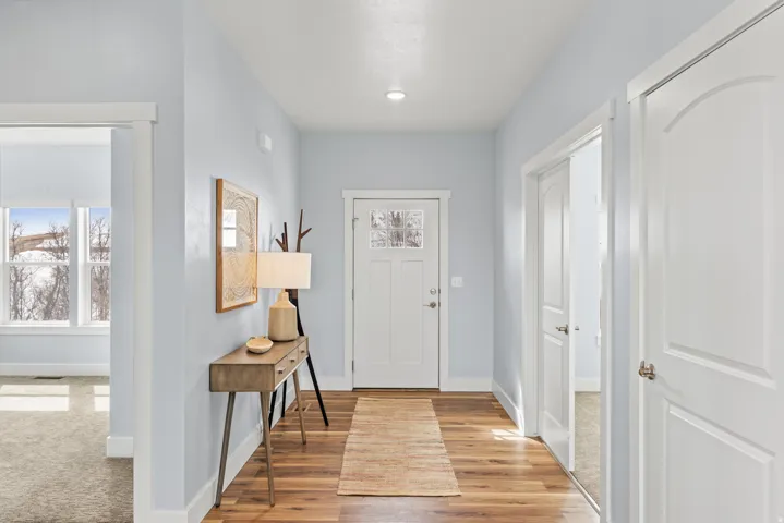 Foyer featuring baseboards and light wood finished floors